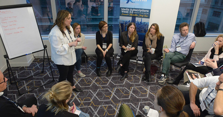 Workshop participants split into three groups to brainstorm ideas for content strategy that drive digital subscriptions.