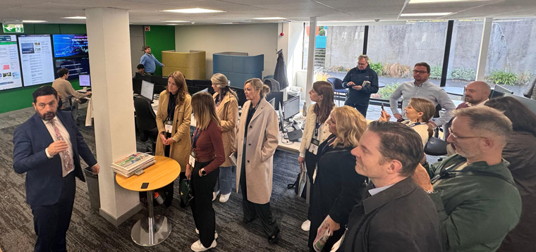 Study tour attendees tour the newsroom at the Business Post.