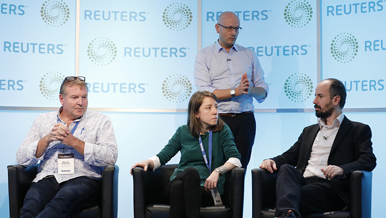 Murray Kirkness of the New Zealand Herald, Guida Pinto of Global Media Group of Portugal, and Emre Kizilkaya of Hurriyet act as market guinea pigs during an INMA town hall. 