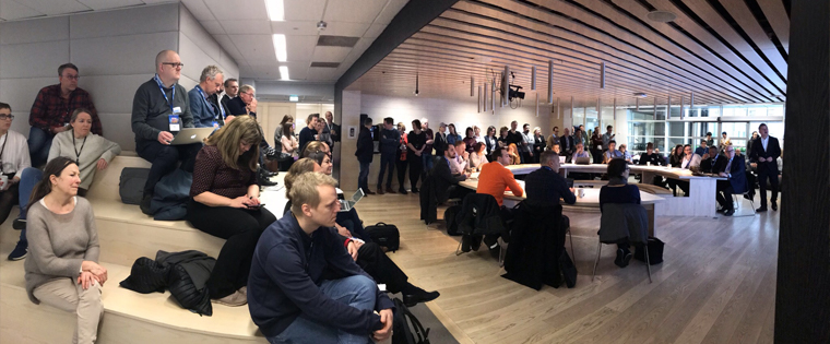 Study tour participants attend a morning editorial meeting of Aftenposten, a daily newspaper owned by Schibsted.