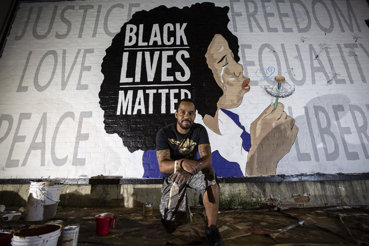 The Black Lives Matter protests after the May 24, 2020, murder of George Floyd, added to the challenges Gannett faced in the past year. Robbie Lee Harris, above, along with Adia Jamille and To-Re-Nee Wolf, are gracing the walls of Tucson buildings with their artwork as part of a Black Lives Matter mural project. Tucson muralist Joe Pagac secured the wall space and bought the paint. Photo by Josh Galemore of Gannett's Arizona Daily Star