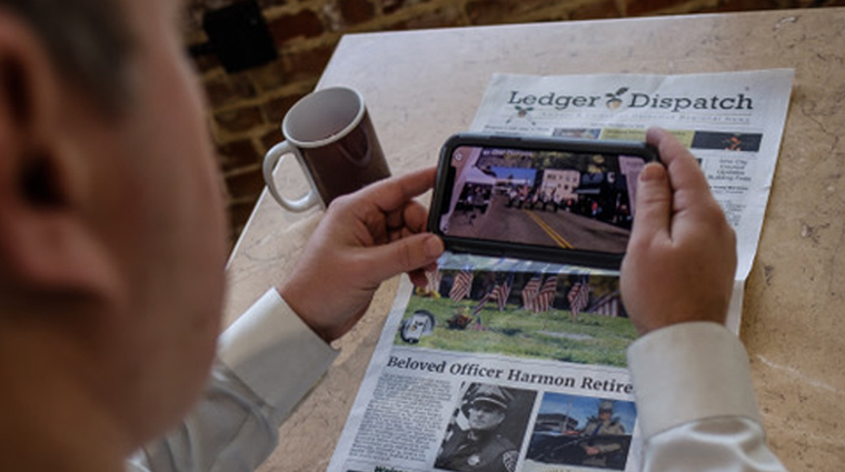 Ledger Dispatch readers can hold a smartphone over AR triggers throughout the print newspaper to launch multi-media content experiences.