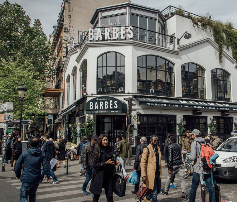 Crowds cross a street in the 18th district of Paris. (Cyril Marcilhacy for The Washington Post)