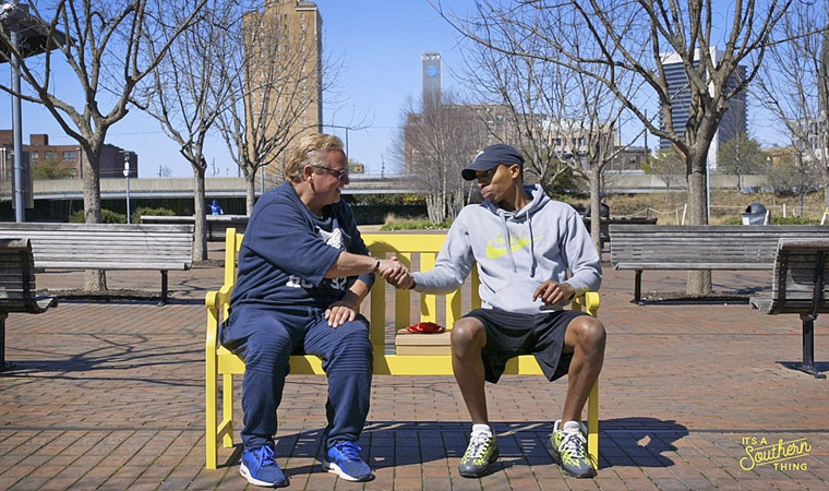 Strangers meet on a park bench to share chocolates and conversation as part of the "Never Met a Stranger" programme. Photo courtesy of It’s a Southern Thing.