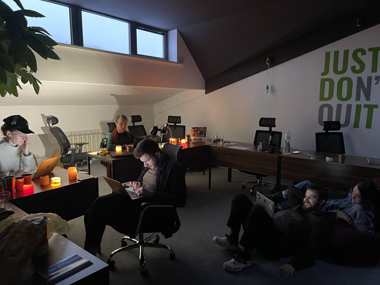 The Kyiv Independent team works by candlelight following a Russian attack on Kyiv’s power infrastructure.