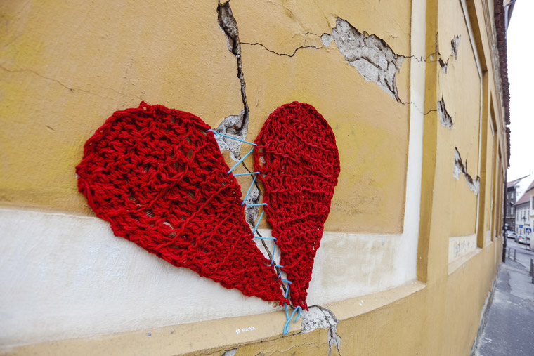 The cover of the catalogue featured this image of a red woollen heart knitted by designer Ivona Martincic on the cracked yellow facade of a school in Zagreb. Photo by Marko Todorov/Cropix