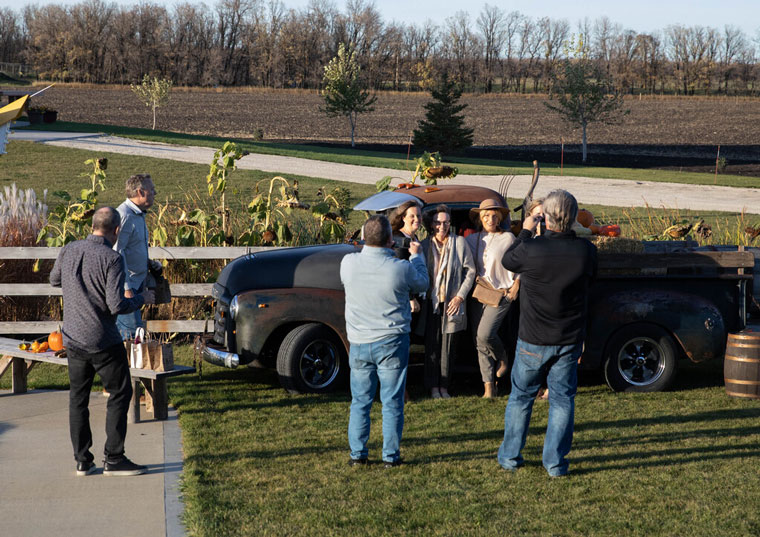 Dinner attendees take advantage of the selfie station set up on the grounds of the venue.
