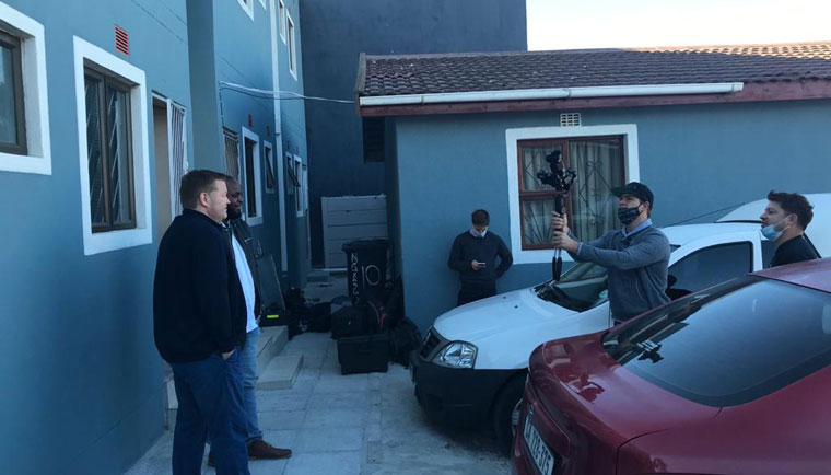 The video crew films the story for BitProp, a property business that provides affordable housing while creating capital for landlords.