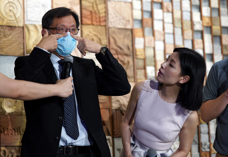 Dr Leong Hoe Nam, an infectious disease specialist from Mount Elizabeth Novena Hospital in Singapore, demonstrating how to wear a face mask during the live show.