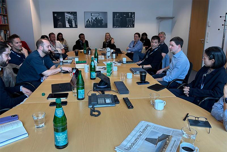 INMA study tour attendees listen as SZ Dossier team leader Finn Mayer-Kuckuk speaks at the Süddeutsche Zeitung office in Berlin.