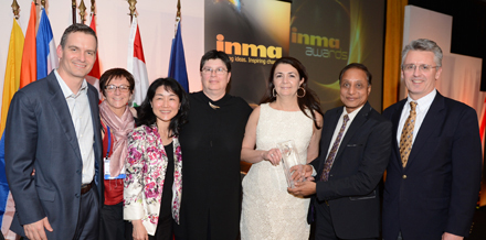 The New York Times team receives the INMA Awards competition's top prize from INMA President Ravi Dhariwal of the Times of India.