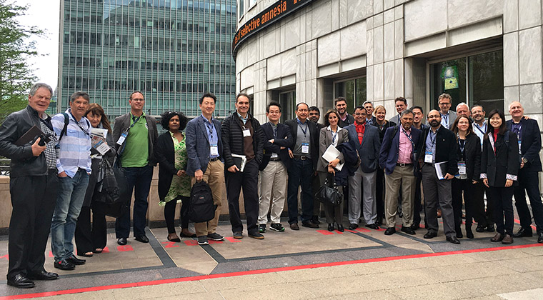 Study tour participants stand in front of Thomson Reuters.