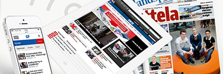 Image of a white iPhone, iPad and a newspaper.