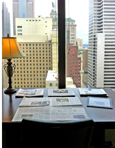 View of an office space looking out into city buildings.