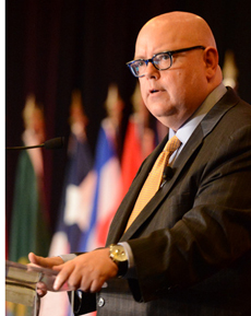 A man with glasses speaking at the INMA World Congress.
