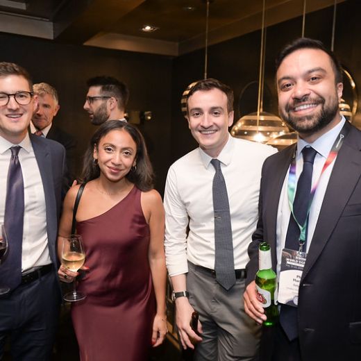 Four delegates with drinks in a restaurant.