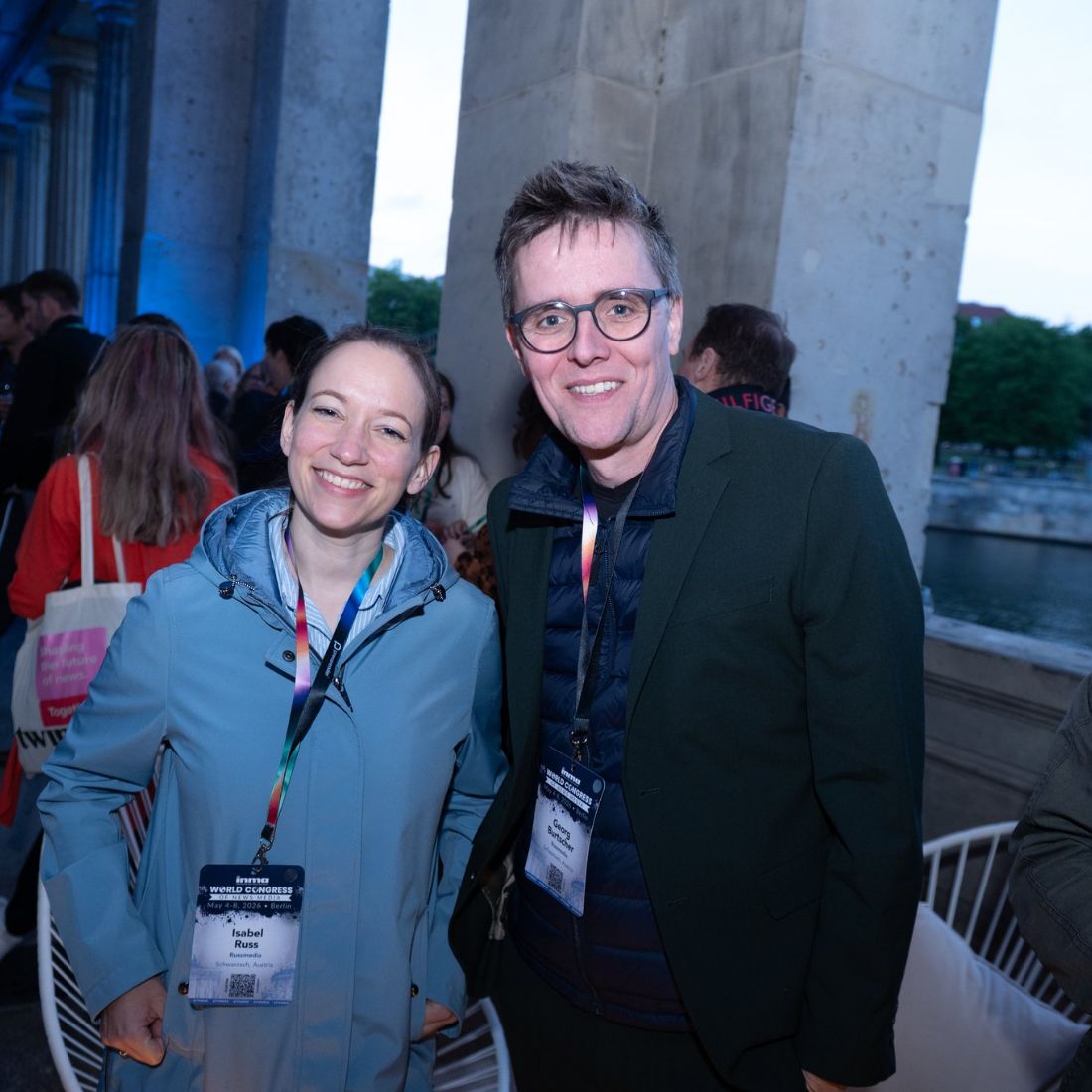 Two delegates outdoors on a waterfront.
