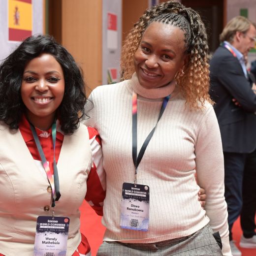 Two delegates side by side on the exhibition floor.